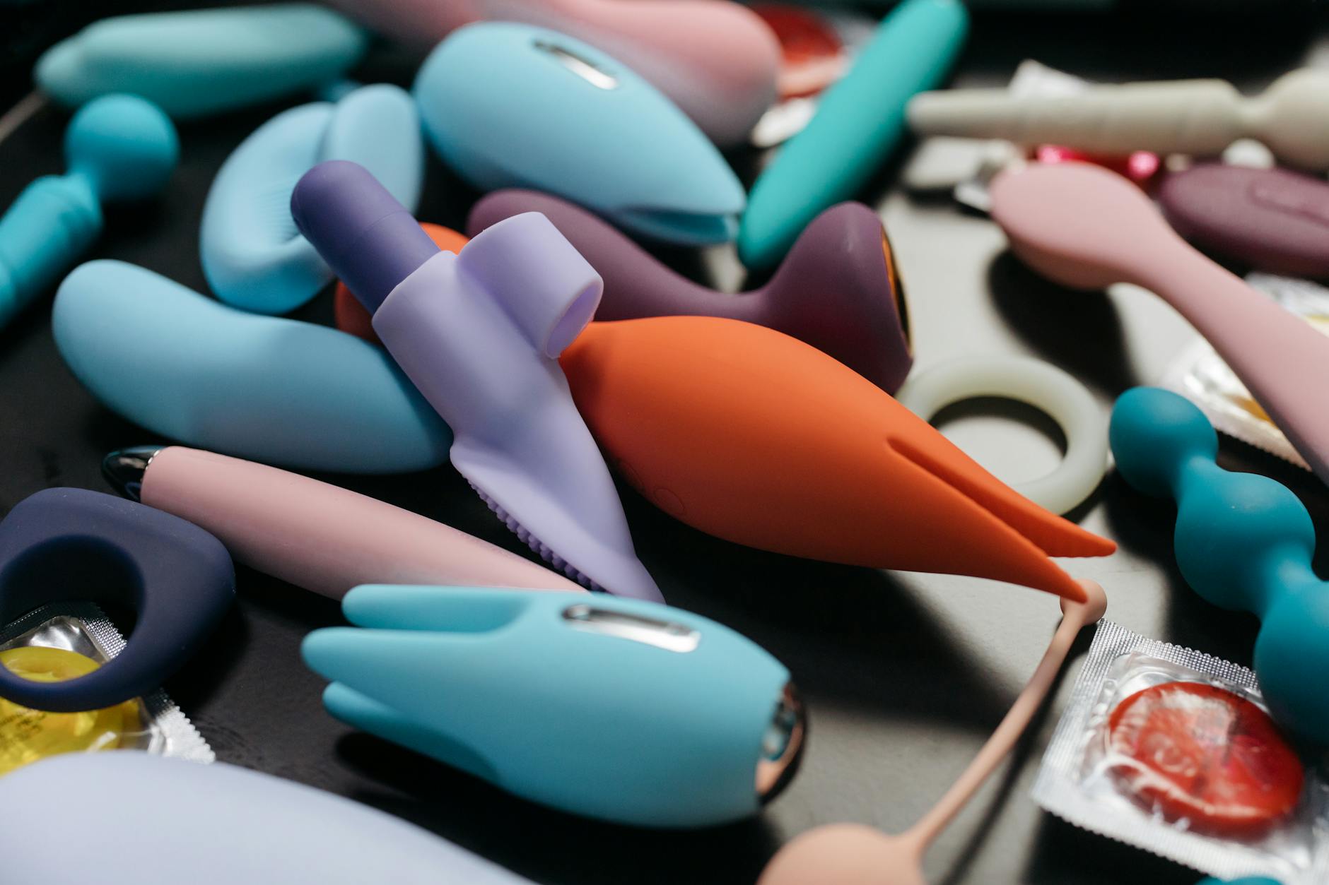 An array of vibrant adult toys including lemon vibrators and clitoral stimulators in close-up view