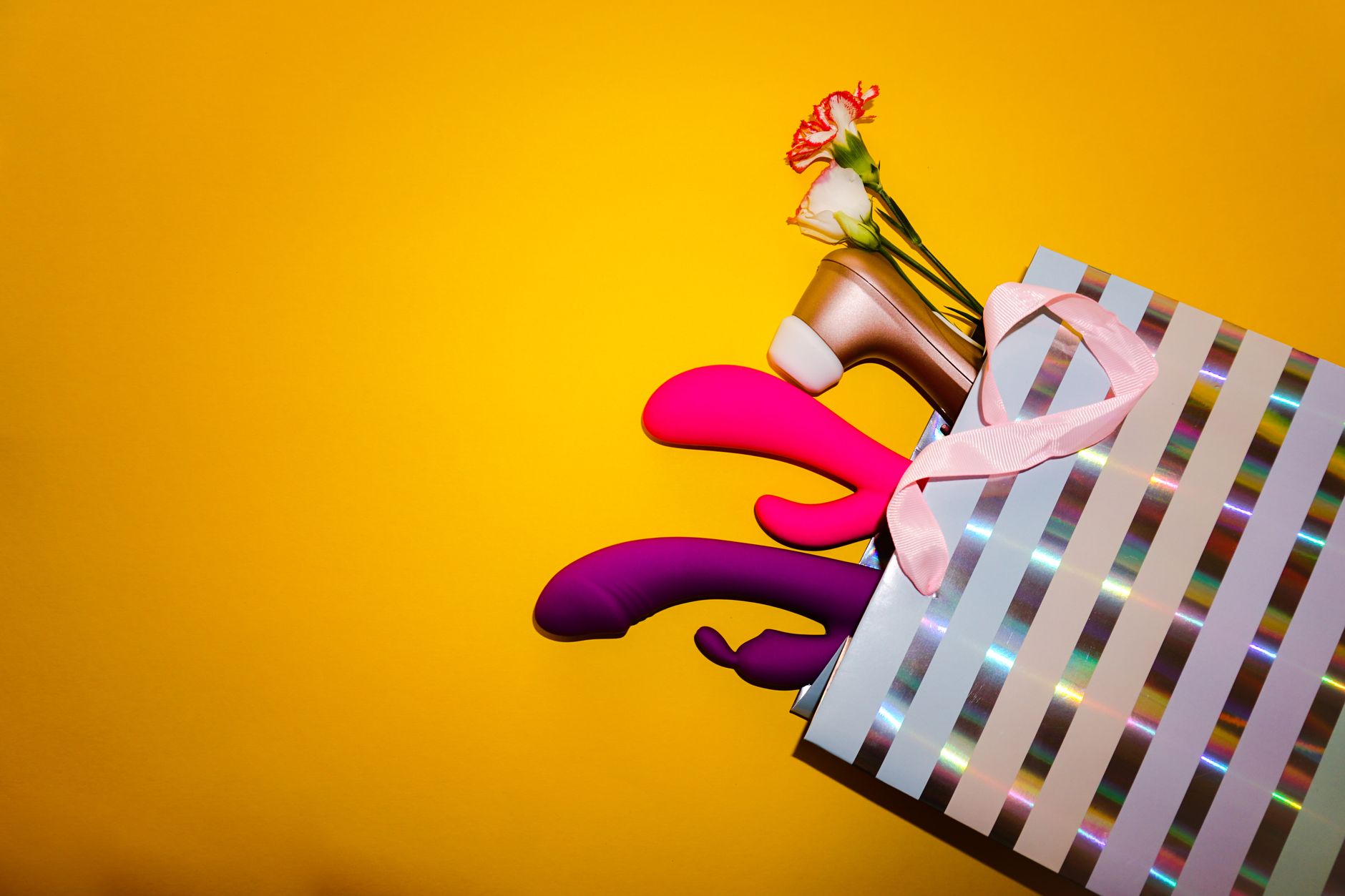 A bright yellow silicone vibrator surrounded by peeled bananas on a yellow background, symbolizing sensual rediscovery
